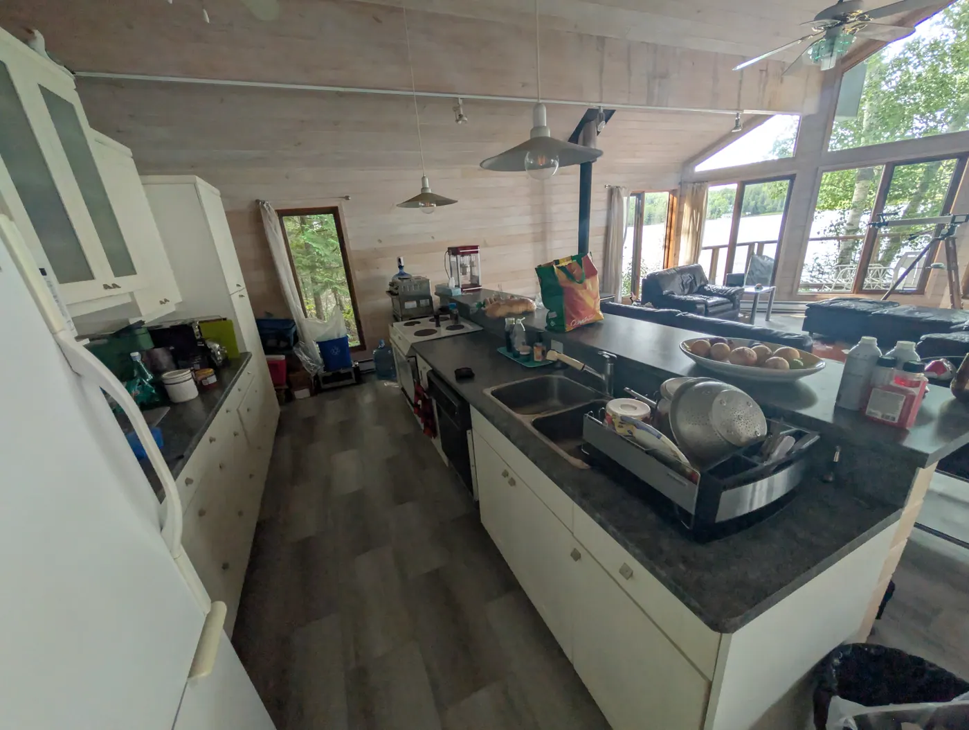 The kitchen under the vaulted pine ceiling.