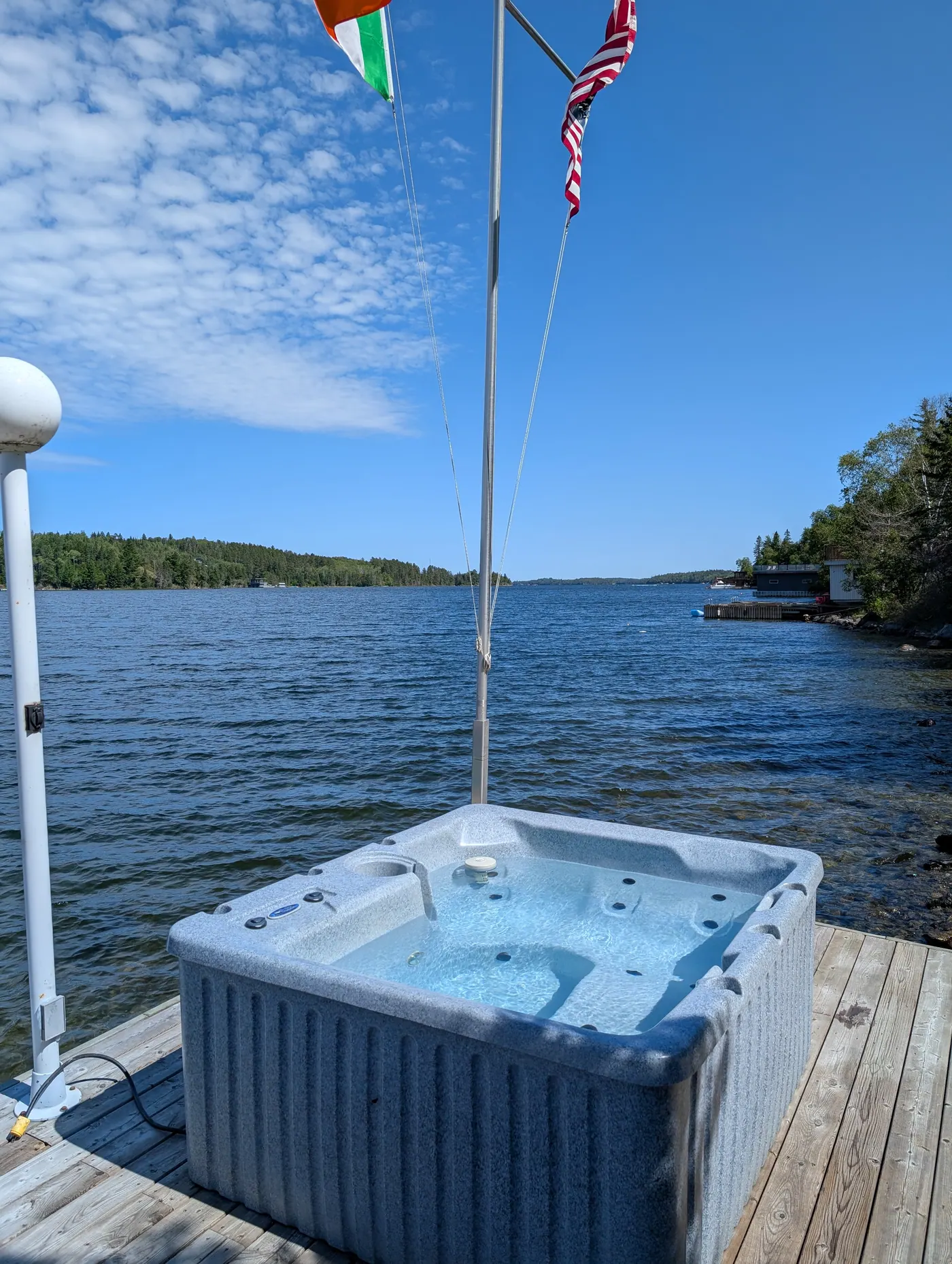 The hot tub set at the water’s edge overlooking the bay.