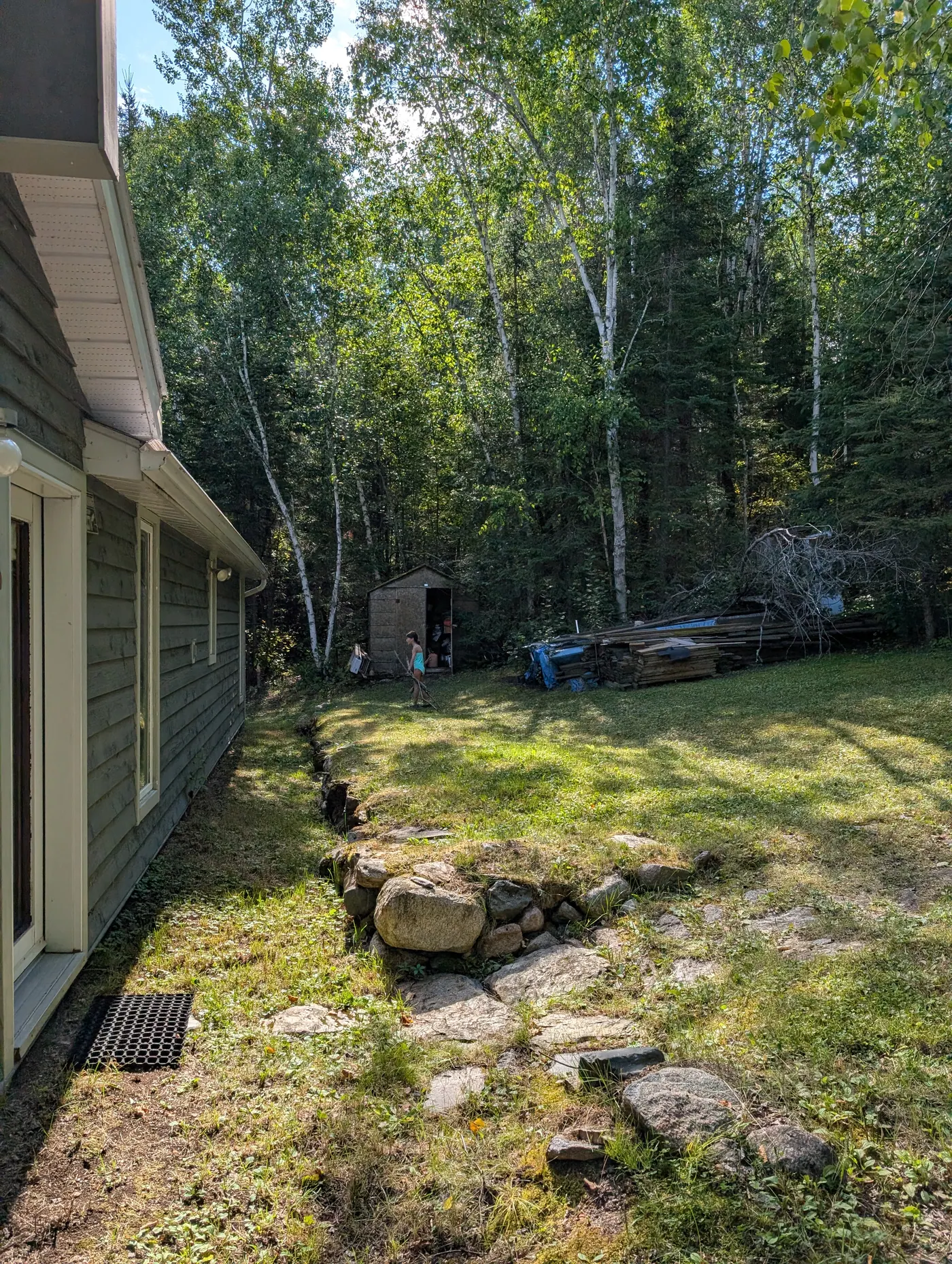 The cottage and the cleared, level ground beside it.