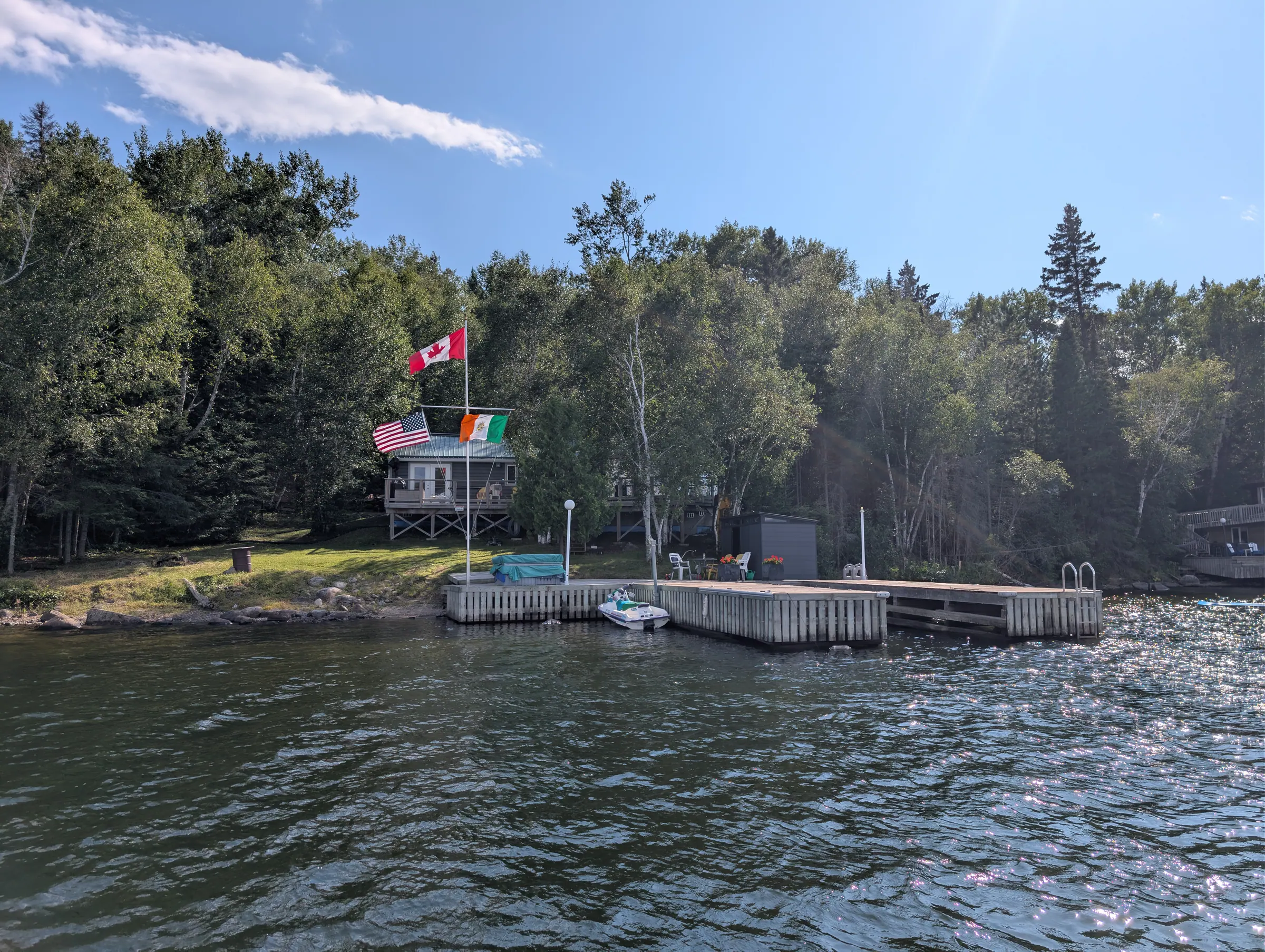 The shoreline and treeline of the property seen from further out in the bay.