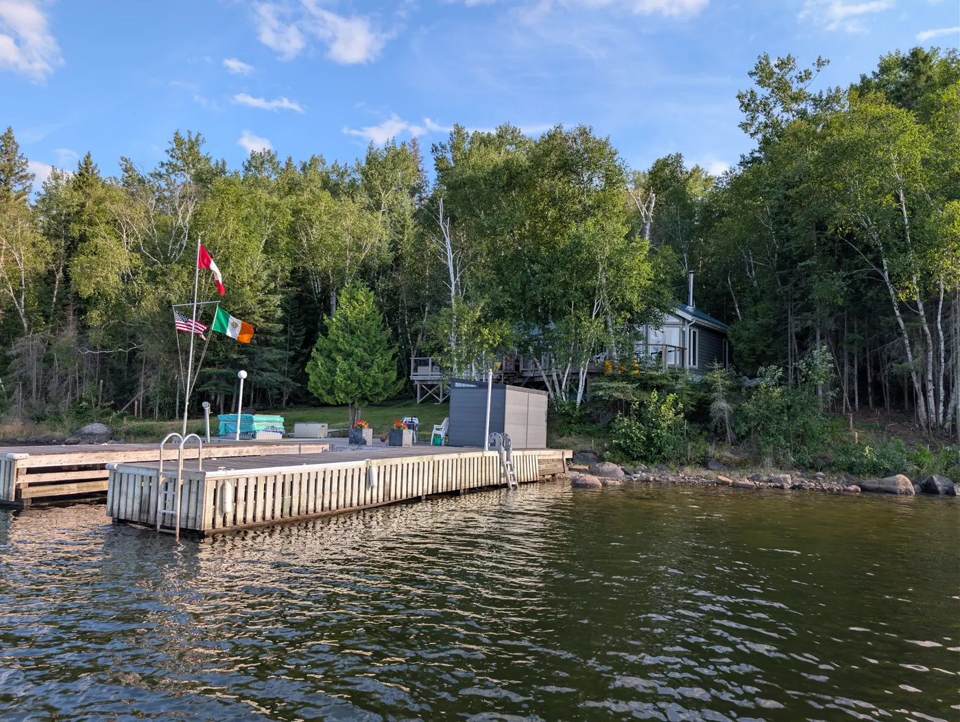 The dock and shoreline seen from out on the water.