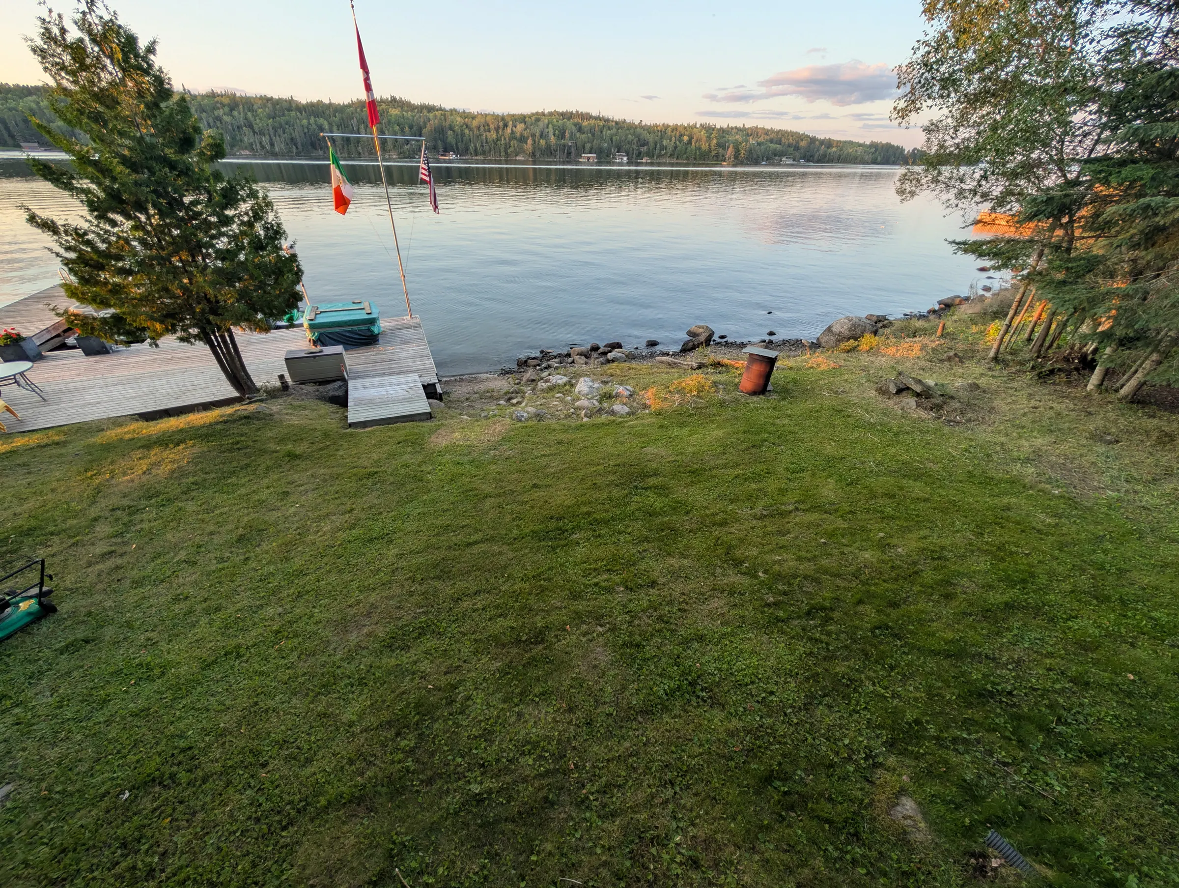Evening light across the lawn, running down to the water and the dock.