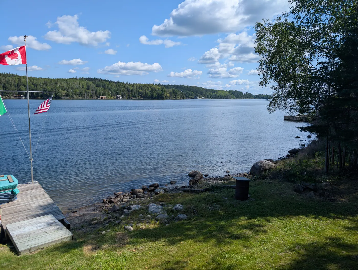 Shoreline rocks and flags with the open bay beyond.