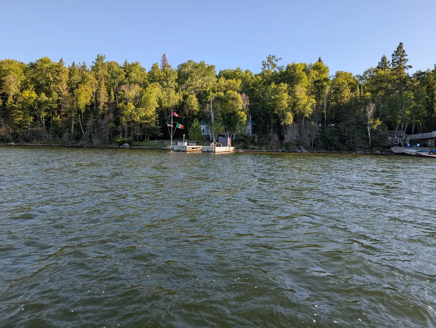 Sheltered water inside Woodchuck Bay with the far treeline beyond.